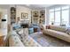 Elegant living room with fireplace, built-in shelving, and large windows at 8069 Middle Bay Ln, Indianapolis, IN 46236