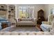 Bright living room featuring hardwood floors, large windows, and elegant furniture at 8069 Middle Bay Ln, Indianapolis, IN 46236