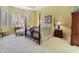 Traditional bedroom with a four-poster bed, sitting area, and neutral carpeting at 8069 Middle Bay Ln, Indianapolis, IN 46236