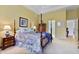 Traditional bedroom with a four-poster bed, neutral carpeting, and an ensuite bathroom at 8069 Middle Bay Ln, Indianapolis, IN 46236