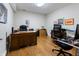 Spacious home office with wood flooring and multiple desks provides a functional and productive workspace at 8069 Middle Bay Ln, Indianapolis, IN 46236
