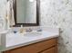 Charming powder room with a unique bird-themed wallpaper, a framed mirror, and a stylish countertop at 8069 Middle Bay Ln, Indianapolis, IN 46236