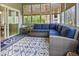 Relaxing sunroom features wicker furniture, an anchor-themed rug, and sliding glass doors at 8069 Middle Bay Ln, Indianapolis, IN 46236