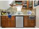 Stylish wet bar featuring custom cabinets, stone accents, a mini-fridge, and ample counter space at 8069 Middle Bay Ln, Indianapolis, IN 46236