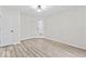 Neutral bedroom features a modern light fixture and ample natural light from the doorway and window at 8216 Glenwillow Ln # 104, Indianapolis, IN 46278
