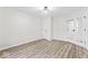 Bright bedroom featuring stylish light fixture, woodgrain floors, and ample natural light from the doorways at 8216 Glenwillow Ln # 104, Indianapolis, IN 46278