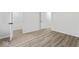Bright bedroom featuring modern light fixture, woodgrain floors, with closet and doorway at 8216 Glenwillow Ln # 104, Indianapolis, IN 46278