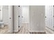 Hallway view showing open doors and access to the en-suite bathroom at 8216 Glenwillow Ln # 104, Indianapolis, IN 46278
