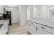 Well-lit kitchen with granite countertops and black appliances at 8216 Glenwillow Ln # 104, Indianapolis, IN 46278
