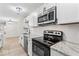 The kitchen features modern stainless steel appliances and updated lighting at 8216 Glenwillow Ln # 104, Indianapolis, IN 46278