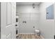 Efficient laundry room featuring modern flooring and ample space for appliances at 8216 Glenwillow Ln # 104, Indianapolis, IN 46278