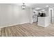 Open-concept space connecting the living area and kitchen with consistent flooring at 8216 Glenwillow Ln # 104, Indianapolis, IN 46278