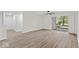 Open-concept living room featuring hardwood flooring and natural light at 8216 Glenwillow Ln # 104, Indianapolis, IN 46278