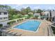 An in-ground swimming pool is surrounded by lounge chairs for residents' enjoyment at 8216 Glenwillow Ln # 104, Indianapolis, IN 46278