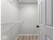 Walk-in closet featuring white wire shelving and a door at 8216 Glenwillow Ln # 104, Indianapolis, IN 46278