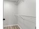 Walk-in closet featuring built-in white wire shelving for easy organization and storage at 8216 Glenwillow Ln # 104, Indianapolis, IN 46278