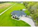 Stunning aerial view of home with large green lawn, driveway, pool and trampoline at 8850 W 225 S, Columbus, IN 47201
