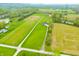 Expansive aerial view of the home on lush acreage, including a pond and nearby wooded area at 8850 W 225 S, Columbus, IN 47201