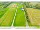 Aerial view showcasing home, pool, long driveway and extensive property at 8850 W 225 S, Columbus, IN 47201