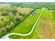 Aerial showcasing pond, trees, property lines, house and long drive at 8850 W 225 S, Columbus, IN 47201