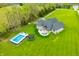 Aerial view of home with pool, trampoline, outdoor seating and spacious back yard at 8850 W 225 S, Columbus, IN 47201
