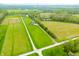 Aerial view of the lot with home, long drive, and surrounding farmland at 8850 W 225 S, Columbus, IN 47201