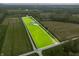 Aerial view of the property showcasing the large lot, home and surrounding trees at 8850 W 225 S, Columbus, IN 47201