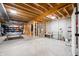 Unfinished basement with exposed beams, studded walls, ping pong table, and concrete floor at 8850 W 225 S, Columbus, IN 47201