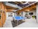 Unfinished basement featuring exposed ceiling beams, exercise equipment and a ping pong table at 8850 W 225 S, Columbus, IN 47201
