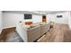 Comfortable finished basement with vinyl plank flooring, large sectional sofa, and media area at 8850 W 225 S, Columbus, IN 47201