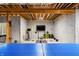 Unfinished basement with exposed beams, concrete floor, and exercise equipment at 8850 W 225 S, Columbus, IN 47201