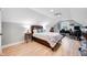 Cozy bedroom with wood floors, neutral walls, and comfortable bed, complemented by a functional workspace at 8850 W 225 S, Columbus, IN 47201