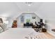 Bright, airy bedroom with dedicated workspace featuring light-colored walls and wood floors at 8850 W 225 S, Columbus, IN 47201