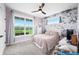 Charming bedroom with floral wallpaper, carpet flooring, ceiling fan, and a serene atmosphere at 8850 W 225 S, Columbus, IN 47201