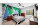 Stylish bedroom with a bold geometric accent wall, carpet flooring, and a ceiling fan at 8850 W 225 S, Columbus, IN 47201