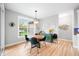 Bright dining room featuring a modern chandelier, a wooden table, and four black chairs at 8850 W 225 S, Columbus, IN 47201