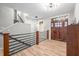 Bright entryway with stylish light fixtures and hardwood floors, leading to the staircase at 8850 W 225 S, Columbus, IN 47201