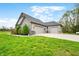 Charming home with a three-car garage and well-manicured lawn at 8850 W 225 S, Columbus, IN 47201