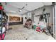 Organized garage featuring a tool rack, work bench, shelving, and a buggy at 8850 W 225 S, Columbus, IN 47201