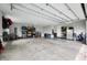 Large garage with shelving, bicycles, tool rack, and epoxy flooring at 8850 W 225 S, Columbus, IN 47201