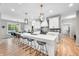 Bright kitchen features a large island with barstool seating and modern pendant lighting at 8850 W 225 S, Columbus, IN 47201