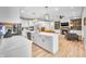 Open-concept kitchen with a large island that seamlessly flows into the living room and fireplace at 8850 W 225 S, Columbus, IN 47201