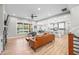 Open-concept living space with a fireplace, hardwood floors, and views of the backyard at 8850 W 225 S, Columbus, IN 47201