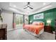 Comfortable main bedroom with a ceiling fan, stylish green accent wall, and natural light at 8850 W 225 S, Columbus, IN 47201