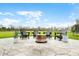 Patio featuring Adirondack chairs, a fire pit and lush green landscaping at 8850 W 225 S, Columbus, IN 47201