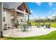 Stamped concrete patio featuring outdoor seating, a grill, and green space at 8850 W 225 S, Columbus, IN 47201