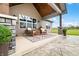 Covered back porch with a seating area and a decorative outdoor rug at 8850 W 225 S, Columbus, IN 47201