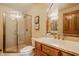 Well-lit bathroom with a glass-enclosed shower, vanity with storage, and contemporary fixtures at 8901 Shetland Ln, Indianapolis, IN 46278