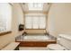 Bright bathroom featuring a built-in tub, skylight, and sleek tile flooring for relaxation and comfort at 8901 Shetland Ln, Indianapolis, IN 46278