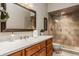 Stylish bathroom with wood cabinets, a framed mirror, and tiled shower area for comfort and convenience at 8901 Shetland Ln, Indianapolis, IN 46278